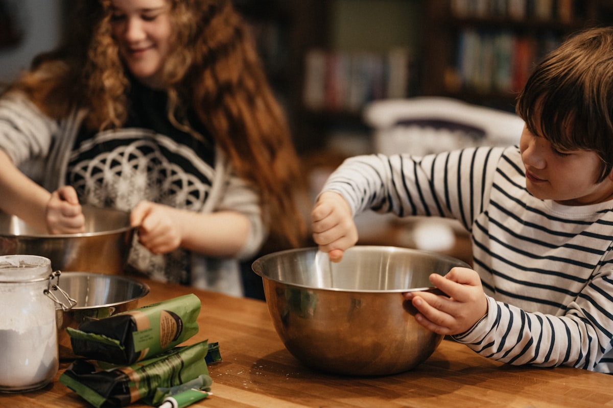 Children helping prepare fresh vegetables in the kitchen